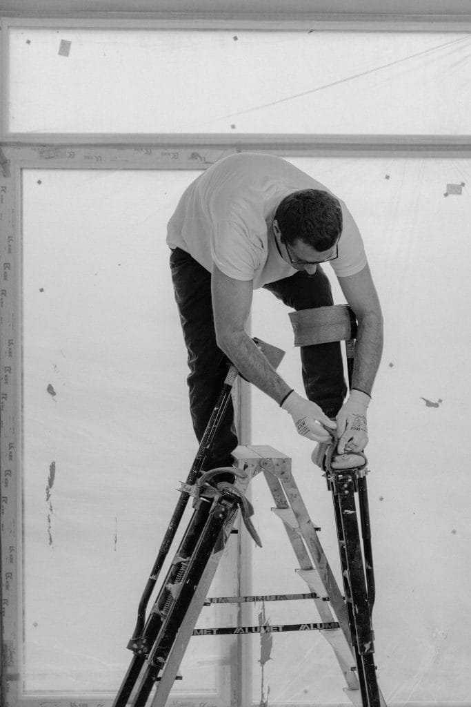 Services 4 Services, Man In White T-Shirt And Black Pants Holding Black And White Snowboard